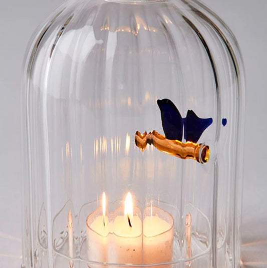 Group image of Ichendorf Milano Birds candle holders, windproof lantern and tealight holder, both with blue bird accents, handmade glass