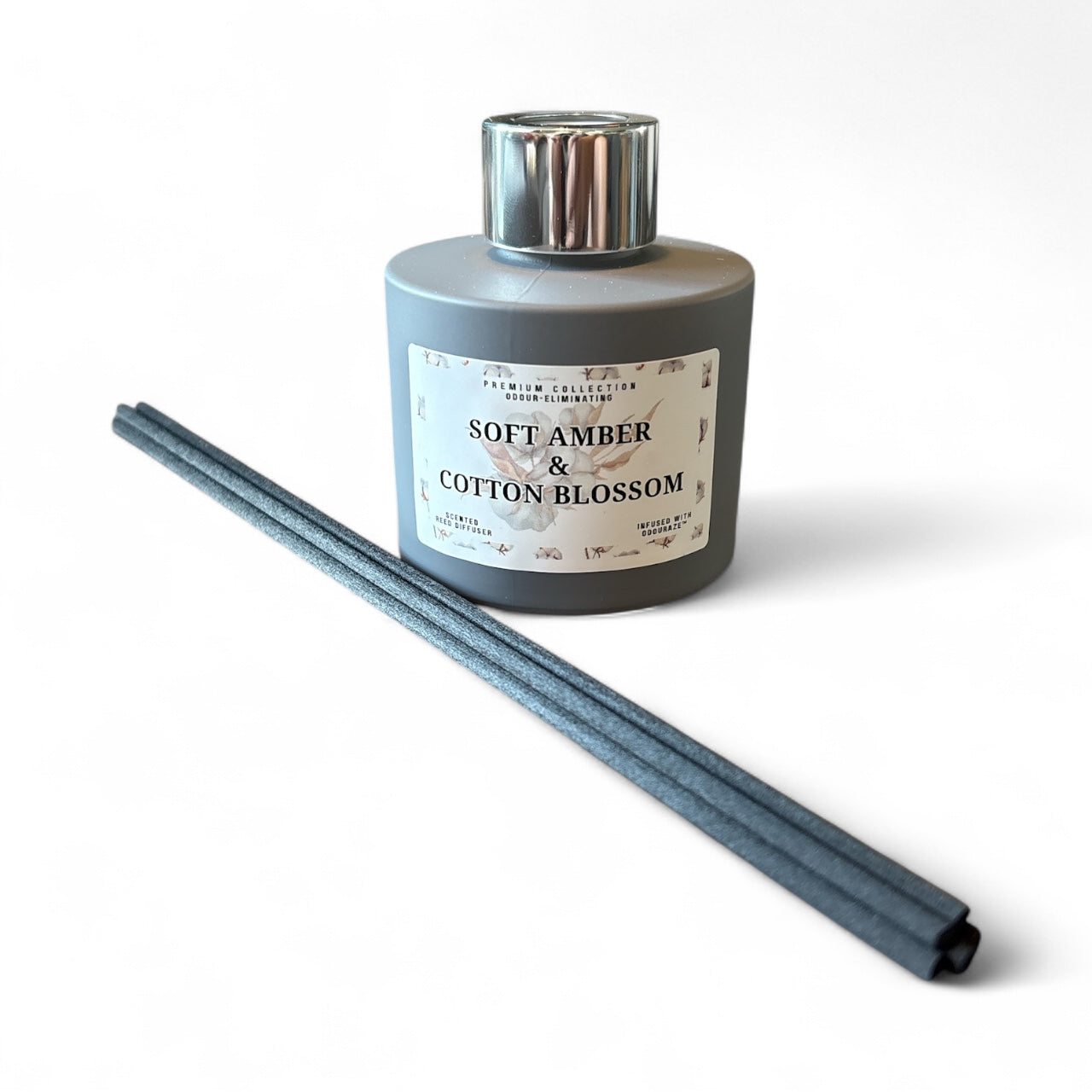 Soft Amber & Cotton Blossom 100ml odour eliminating reed diffuser bottle with matte finish and black reeds, gentle floral and amber scent, handmade in London