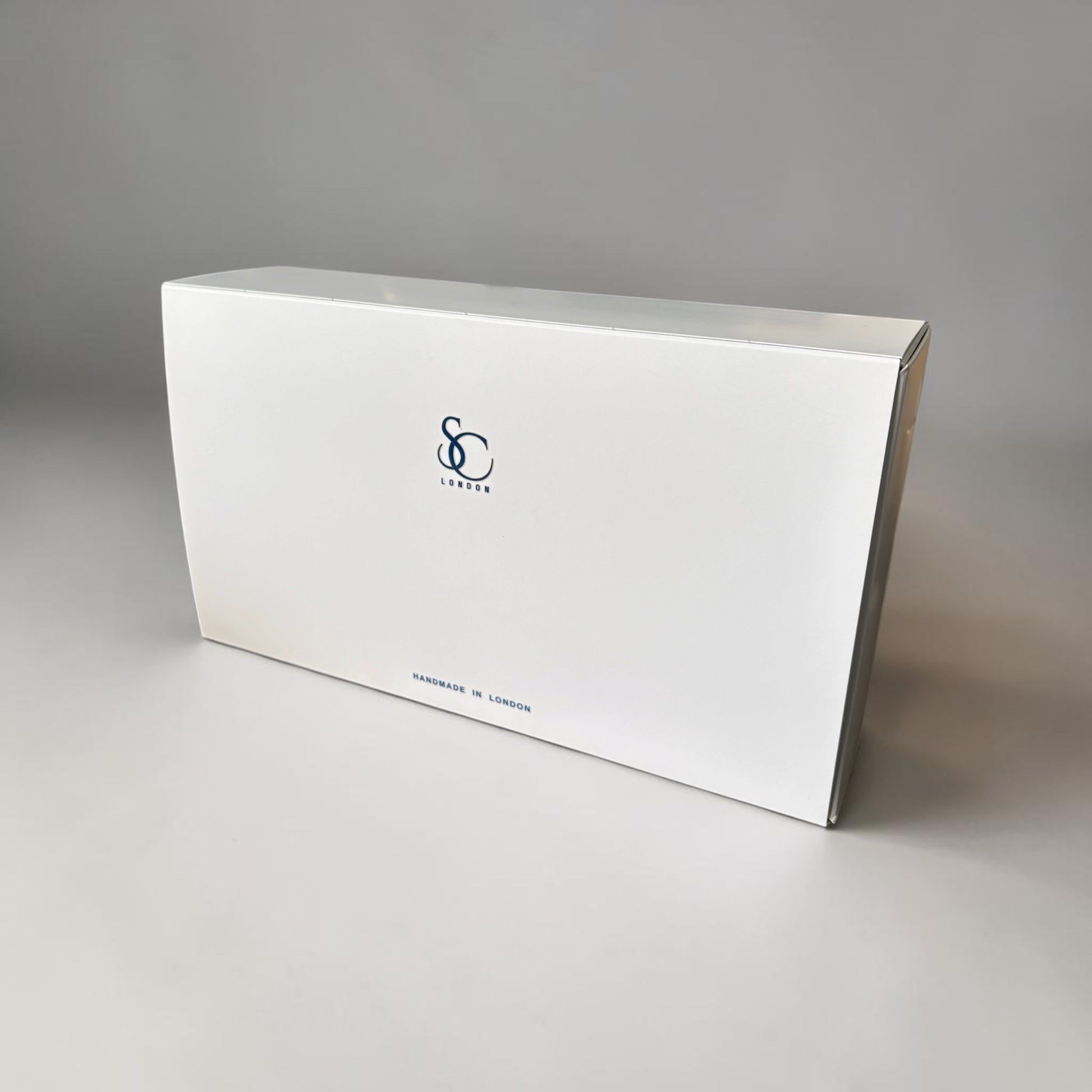White rectangular box with a logo on a gray background