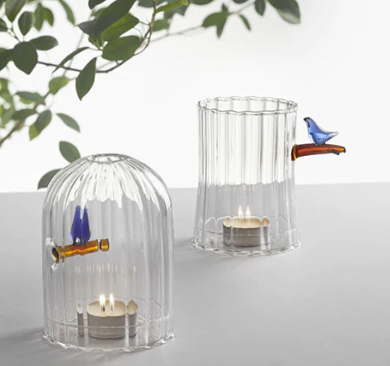 Close-up of Ichendorf Milano windproof candle holder with blue bird detail, handmade borosilicate glass, tealight burning inside