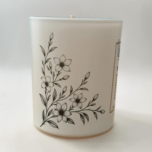 Jasmine and Soft Amber 9cl candle showing delicate floral engravings on matt white glass