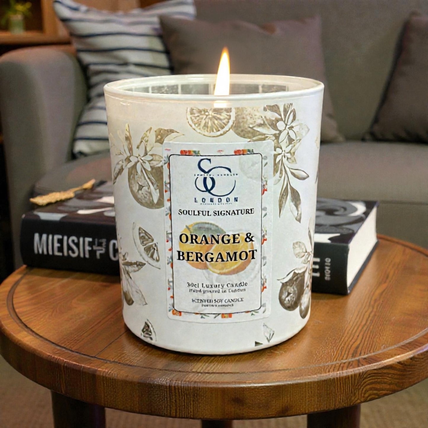 Lit Orange & Bergamot luxury soy candle in engraved white glass vessel