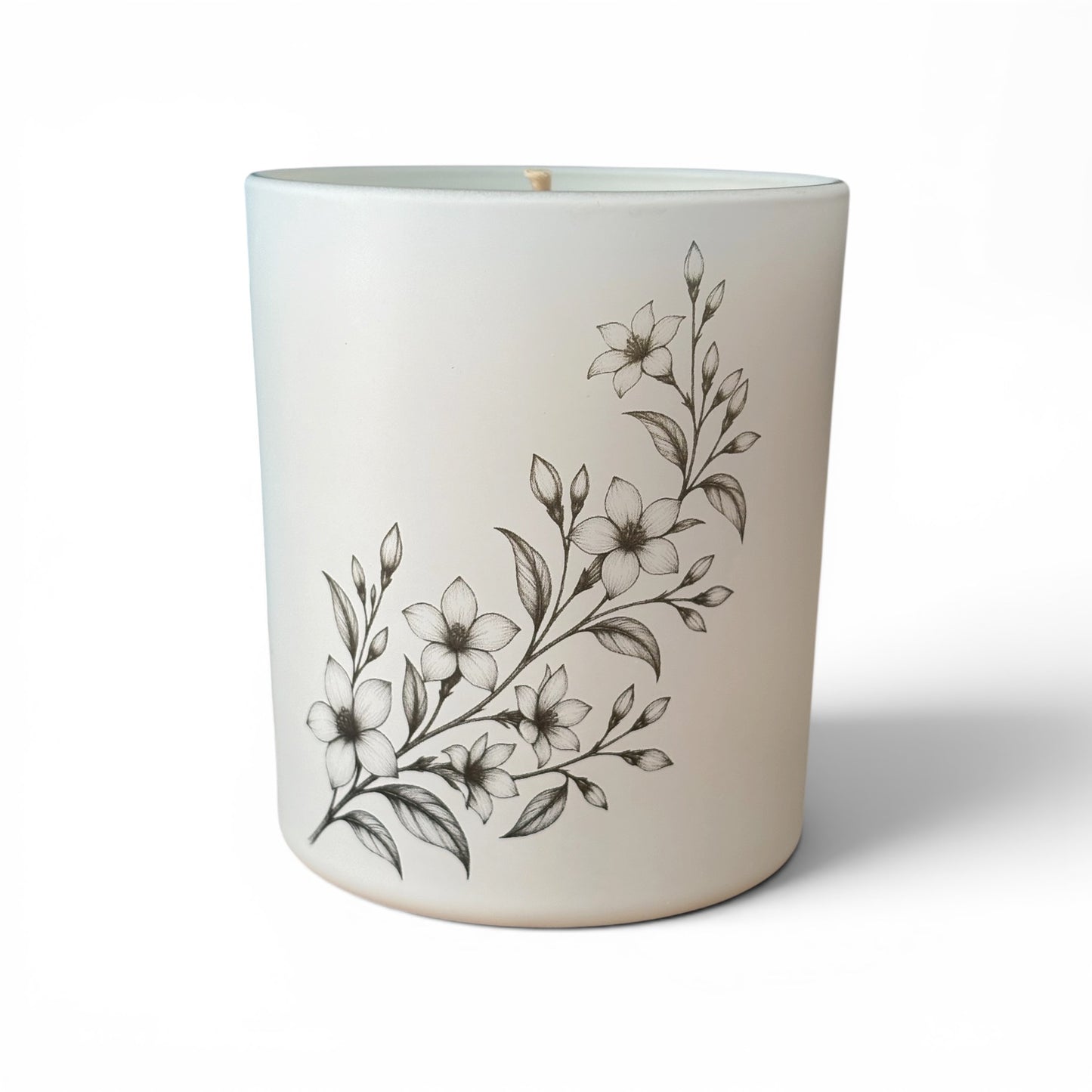 Matt white Jasmine and Soft Amber candle showing delicate botanical engravings around the glass