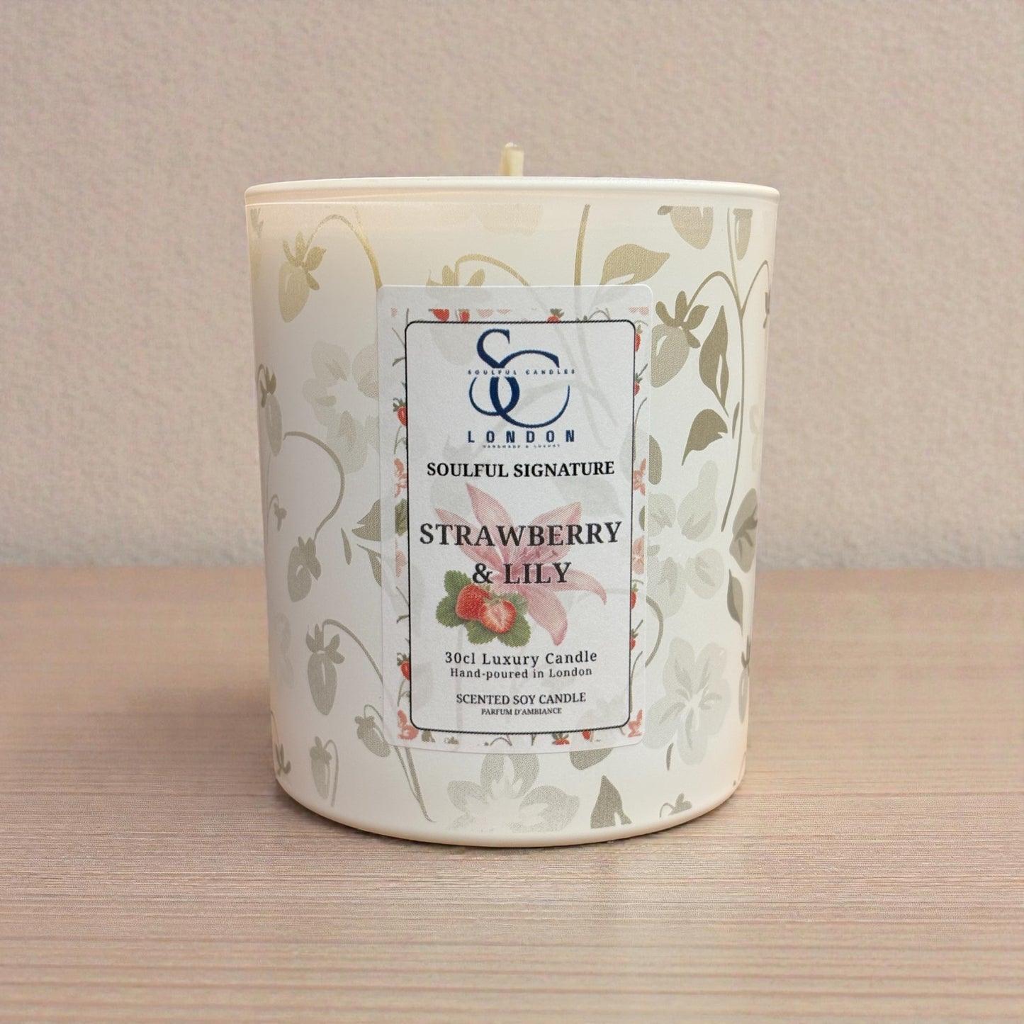 Strawberry & Lily Luxury Soy Candle – 30cl Scented candle with a label on a wooden surface