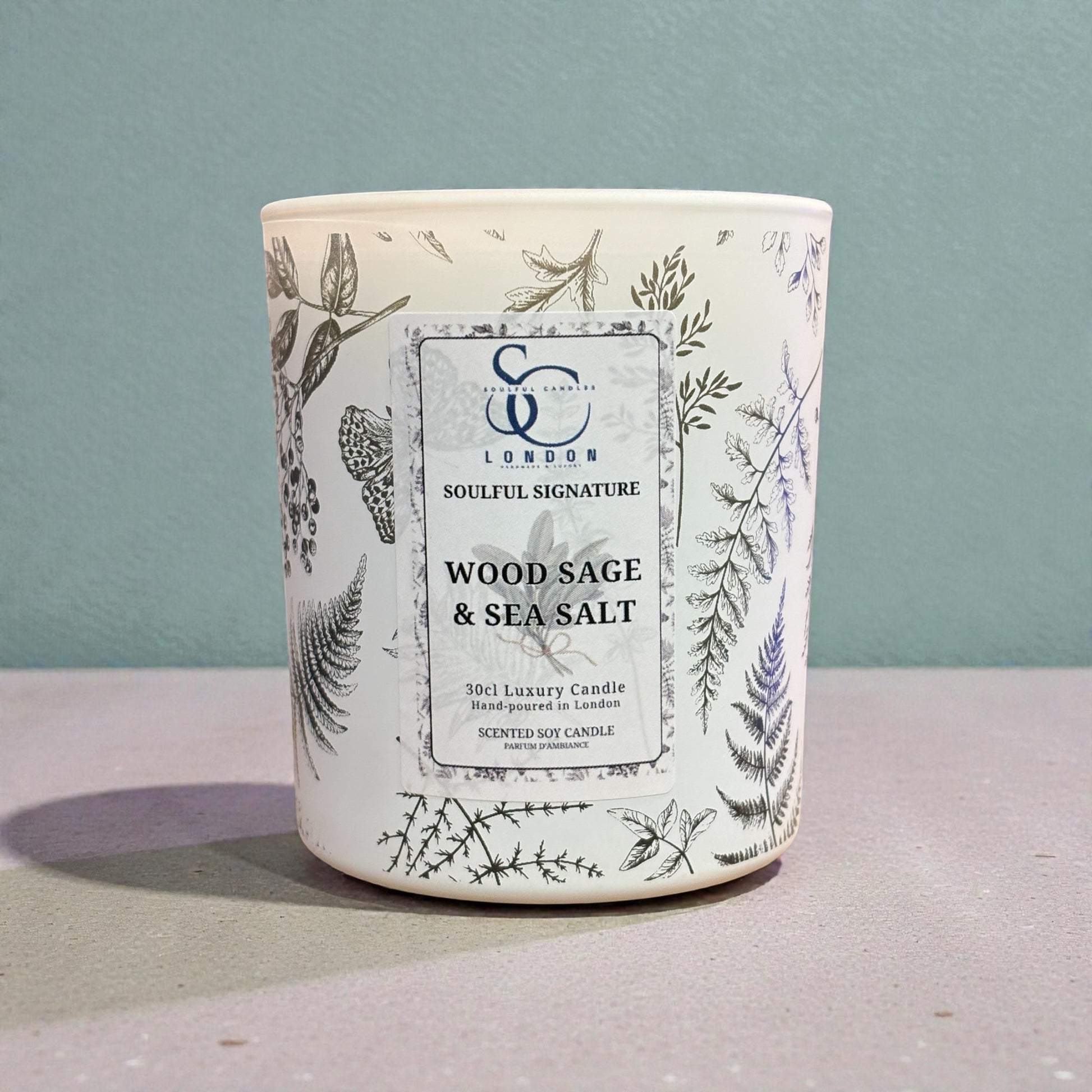 Wood Sage & Sea Salt luxury soy candle 30cl in engraved botanical glass on wooden table