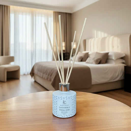 Reed diffuser  on a wooden table in a room setting