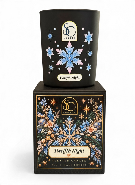 Twelfth Night 9cl scented soy candle by Soulful Candles London, featuring blue and pink snowflakes on black glass, displayed on its matching festive gift box.