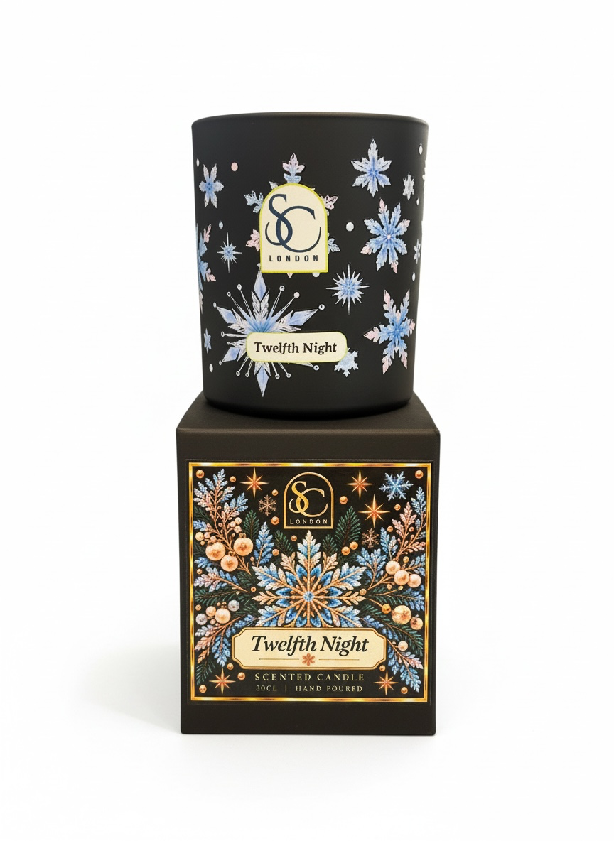 Twelfth Night 30cl scented soy candle by Soulful Candles London, featuring blue and pink snowflakes on black glass, displayed on its matching festive gift box.